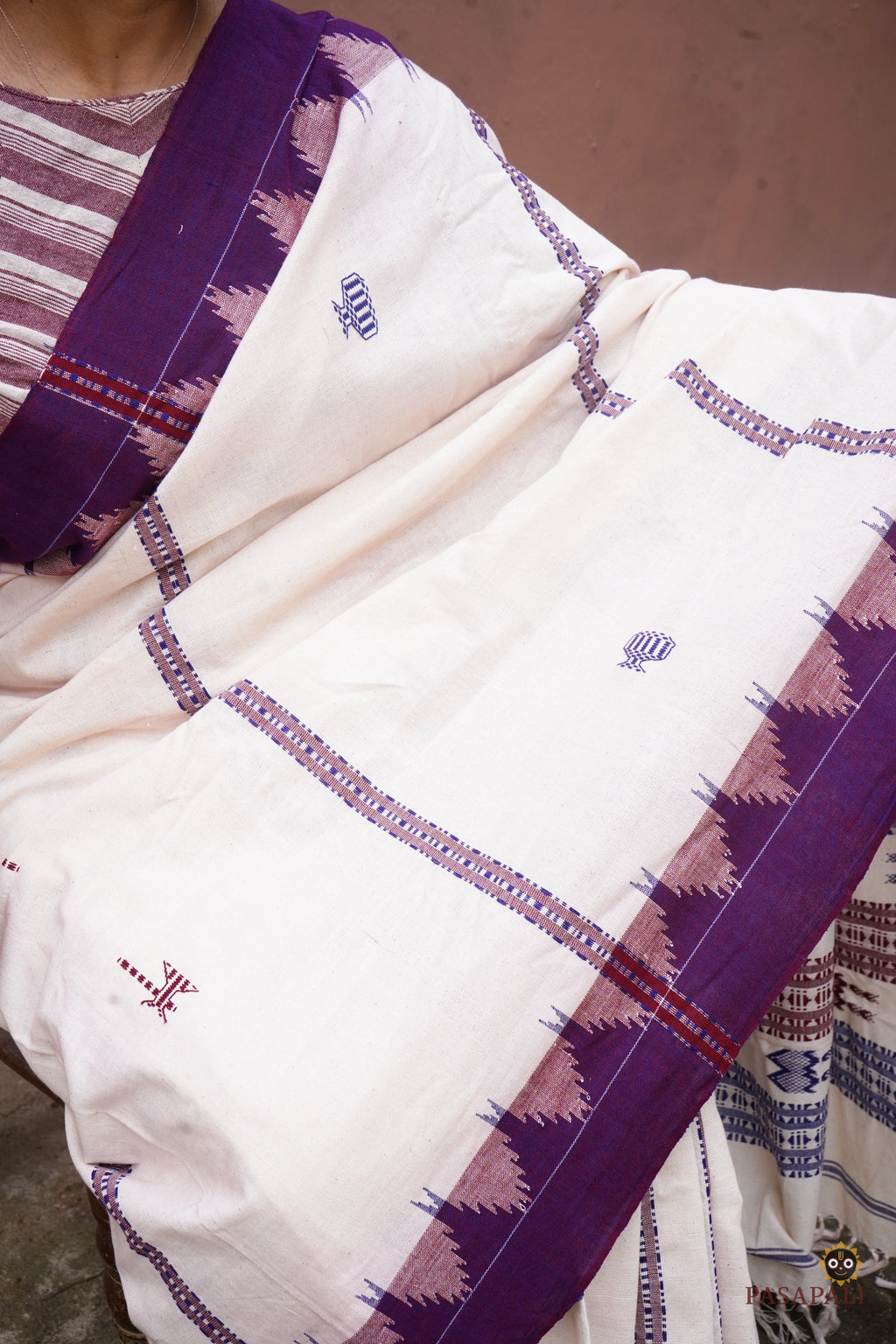 Handloom drape view of Nirjhari Kotpad saree — natural vegetable dye, tribal kumbha border, Pasapali Odisha