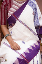 Pharsa axe motif detail on Nirjhari Kotpad saree body — extra-weft tribal weaving, off-white cotton, Pasapali