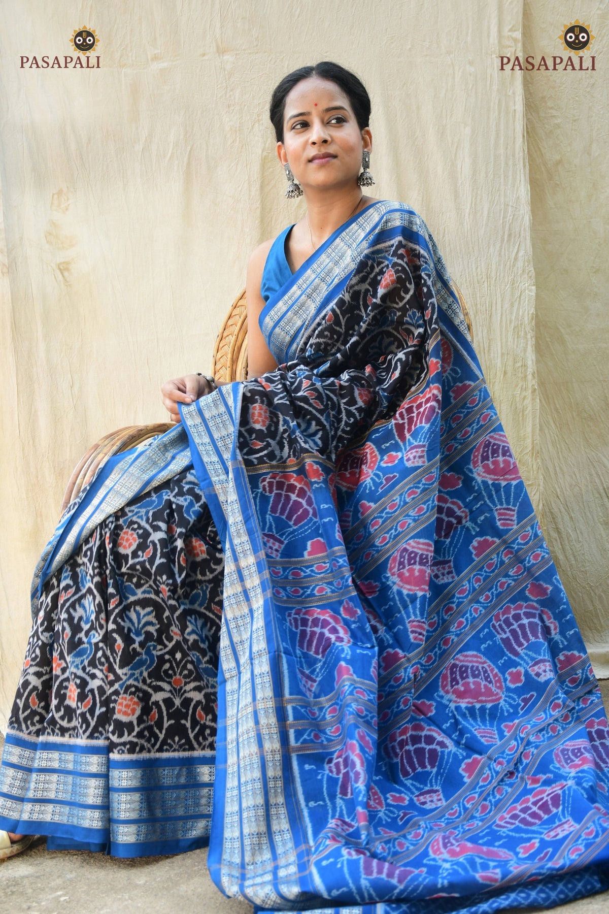 Handloom drape view of Nishigandha — GI certified Sambalpuri Bandha saree in black mercerized cotton, Pasapali Odisha