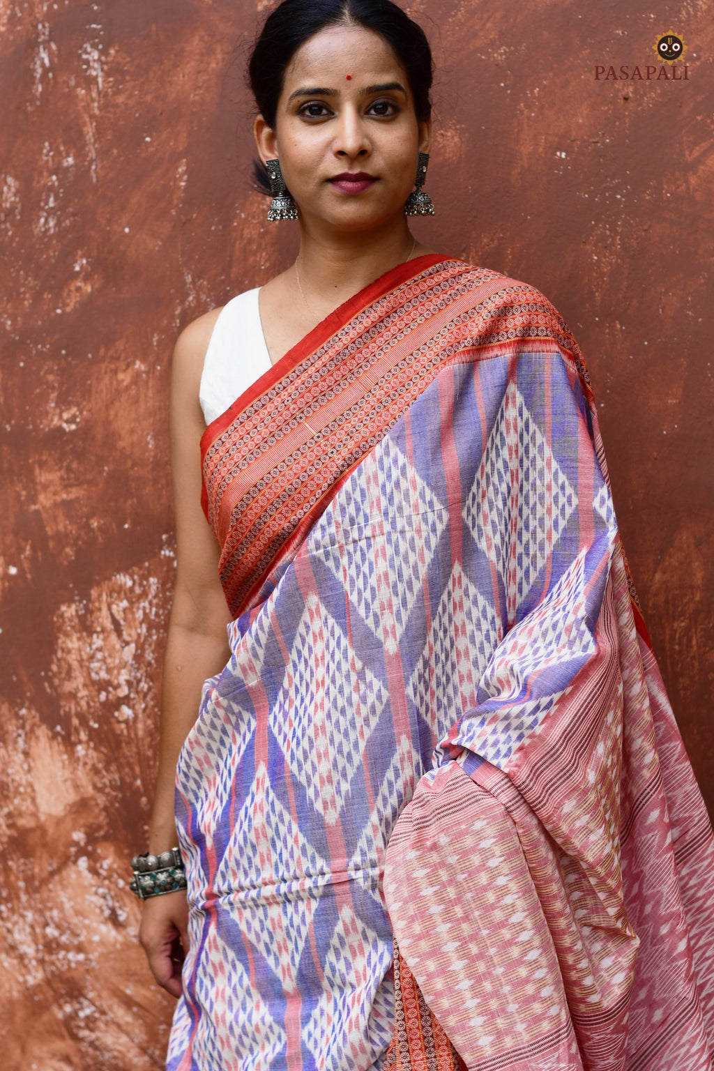 Rudraksha motif traditional double border close-up on Nityarekha Sambalpuri Bandha saree in rust and light blue