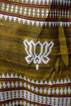 Pallava Kotpad saree border close-up — raised Kumbha temple motif, multi-shuttle interlocking, golden Tussar