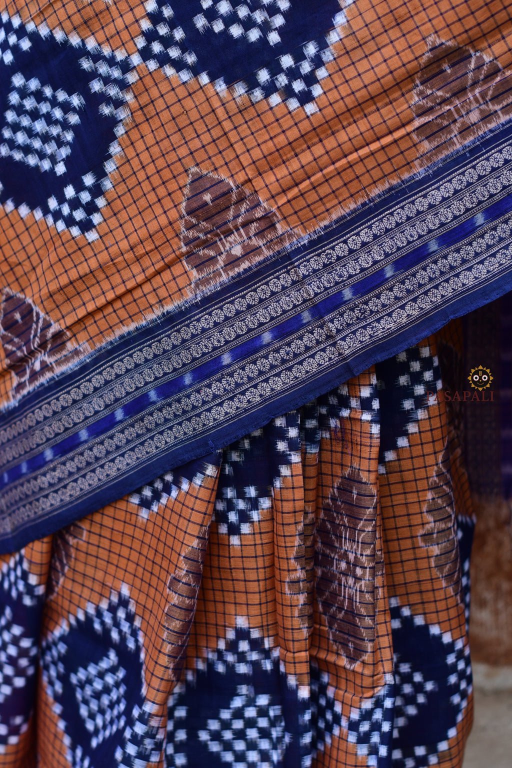 Pashini Sambalpuri handloom saree front drape — brown mercerized cotton with blue Pasapali saktapar body pattern
