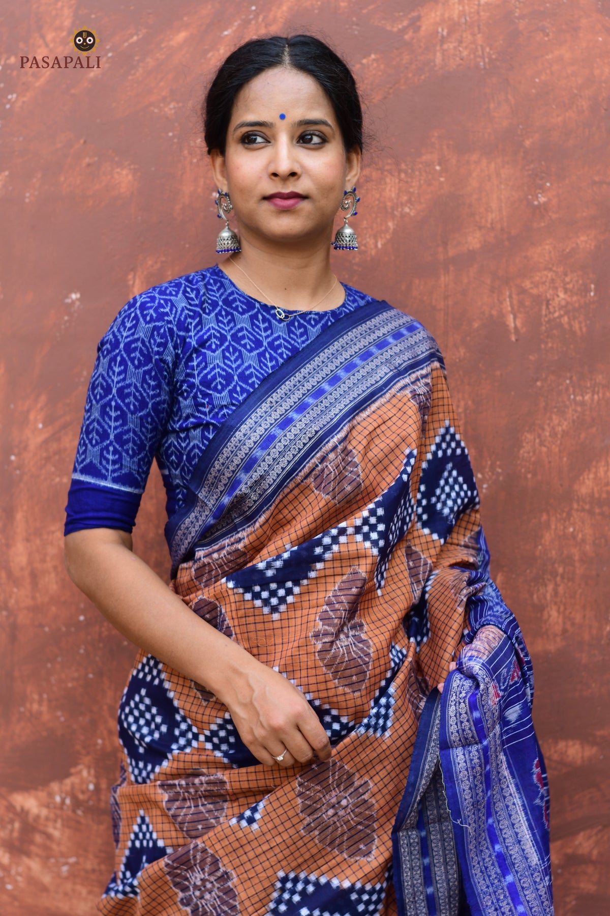 Folded view of Pashini Brown Sambalpuri handloom cotton saree showing check body pattern and Rudraksha border