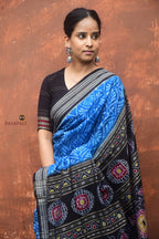 Rajani Sambalpuri cotton saree rudraksha border close-up — black on blue, Bandha ikat edge, Bhulia weavers Odisha