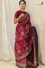 Load image into Gallery viewer, Overhead full view of Ramā maroon Sambalpuri cotton saree — Laxmi Yantra pallu, fish border, jhoti body, Pasapali

