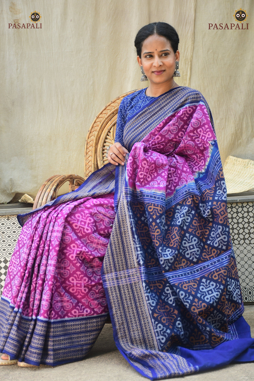 Rekha purple Sambalpuri handloom saree folded — blue pallu jhoti motif visible, Bandha ikat weave | Pasapali