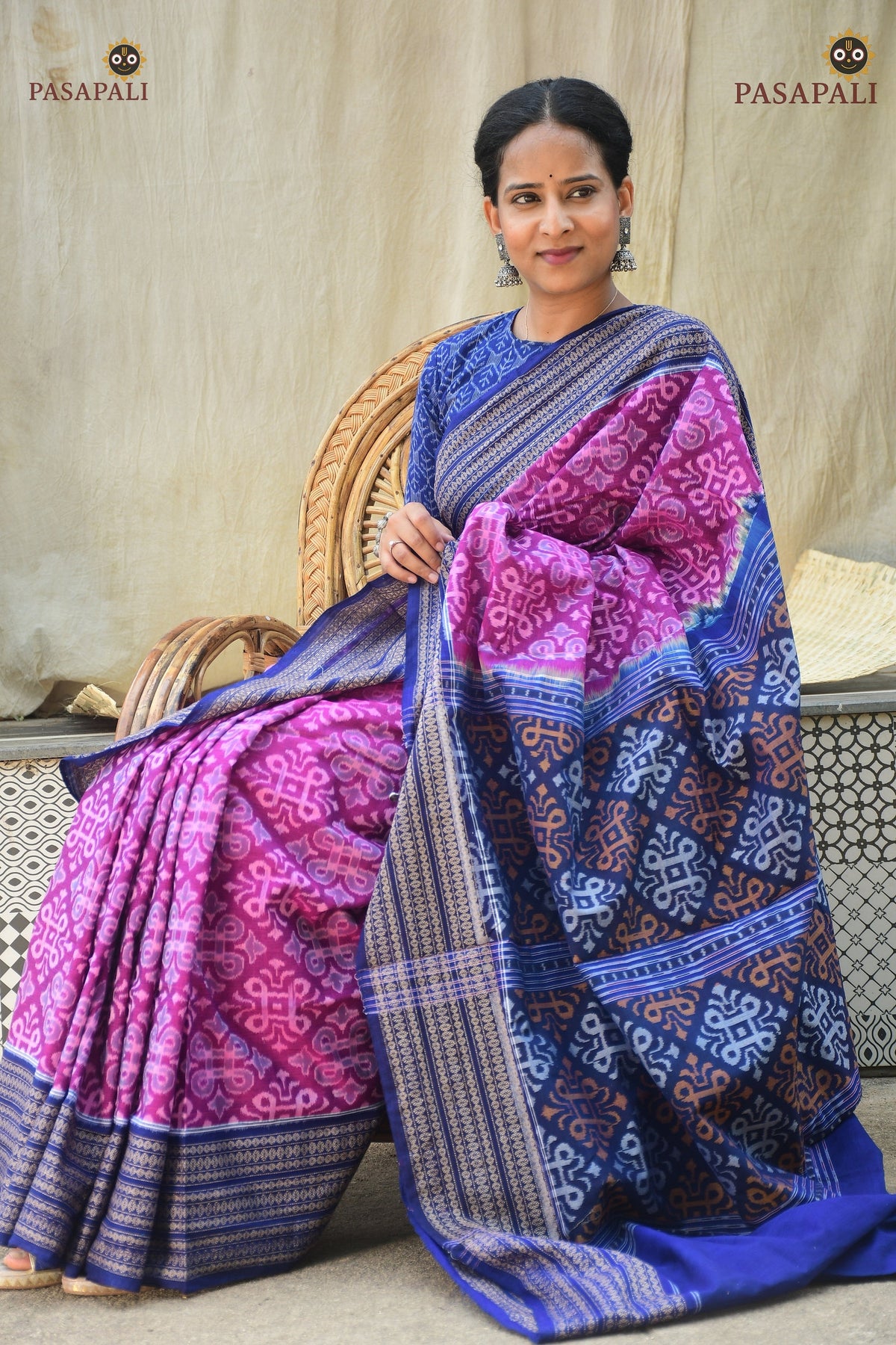 Rekha purple Sambalpuri handloom saree folded — blue pallu jhoti motif visible, Bandha ikat weave | Pasapali