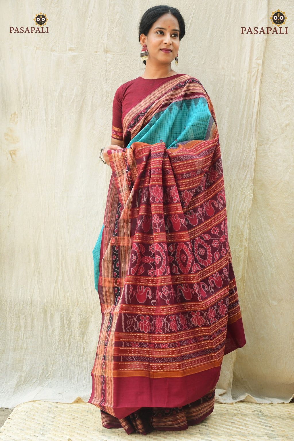 Front drape of Sachipar Rama Green Sambalpuri cotton saree showing fish buta body and chevron ikat border by Pasapali