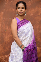 Shabari Sambalpuri Bandha saree front drape — white mercerized cotton with purple ikat border by Pasapali