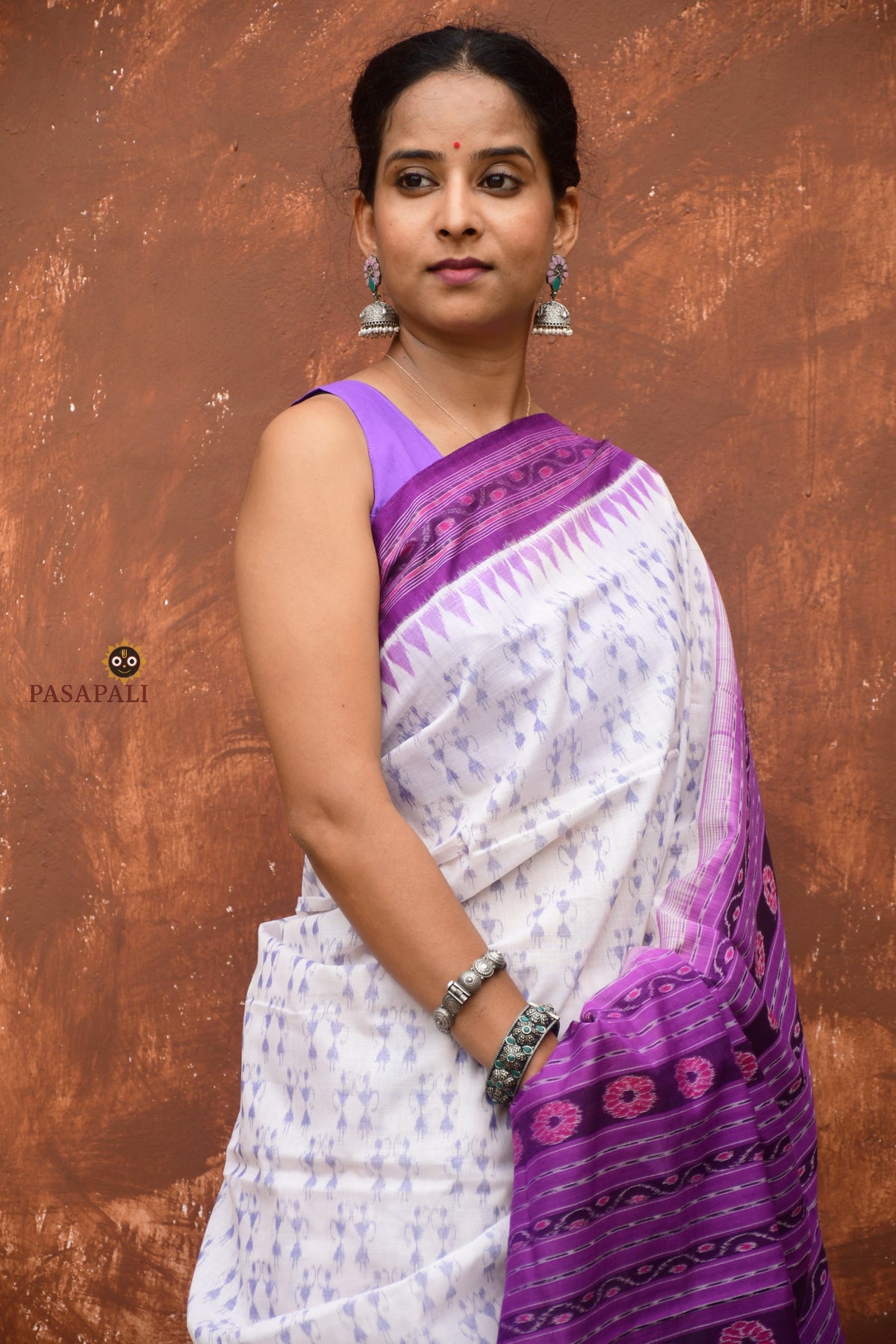 Shabari Sambalpuri Bandha saree front drape — white mercerized cotton with purple ikat border by Pasapali