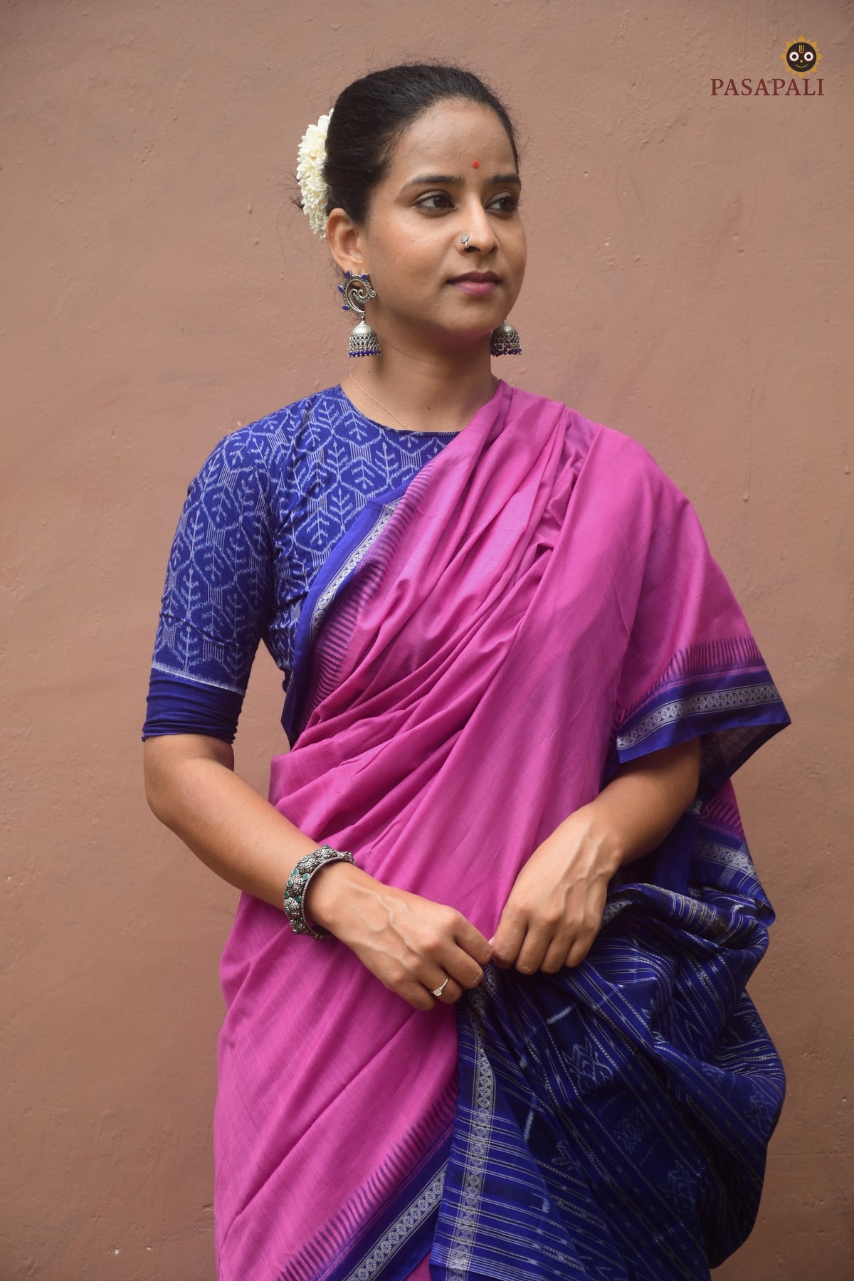 Front drape of Shailabala pink Sambalpuri cotton saree — solid pink body with blue kathiphera border. Pasapali.