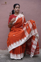 Kumbha border close-up on Shalmali Kotpad saree — multi-shuttle interlocking raised temple form, orange cotton
