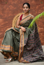 Load image into Gallery viewer, Smritirekha Greenish Grey Sambalpuri Bandha saree folded showing body and border — Pasapali
