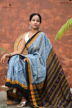 Load image into Gallery viewer, Smritirekha Sambalpuri Bandha saree flat lay — light blue body, golden black border, flower fish pallu, Pasapali
