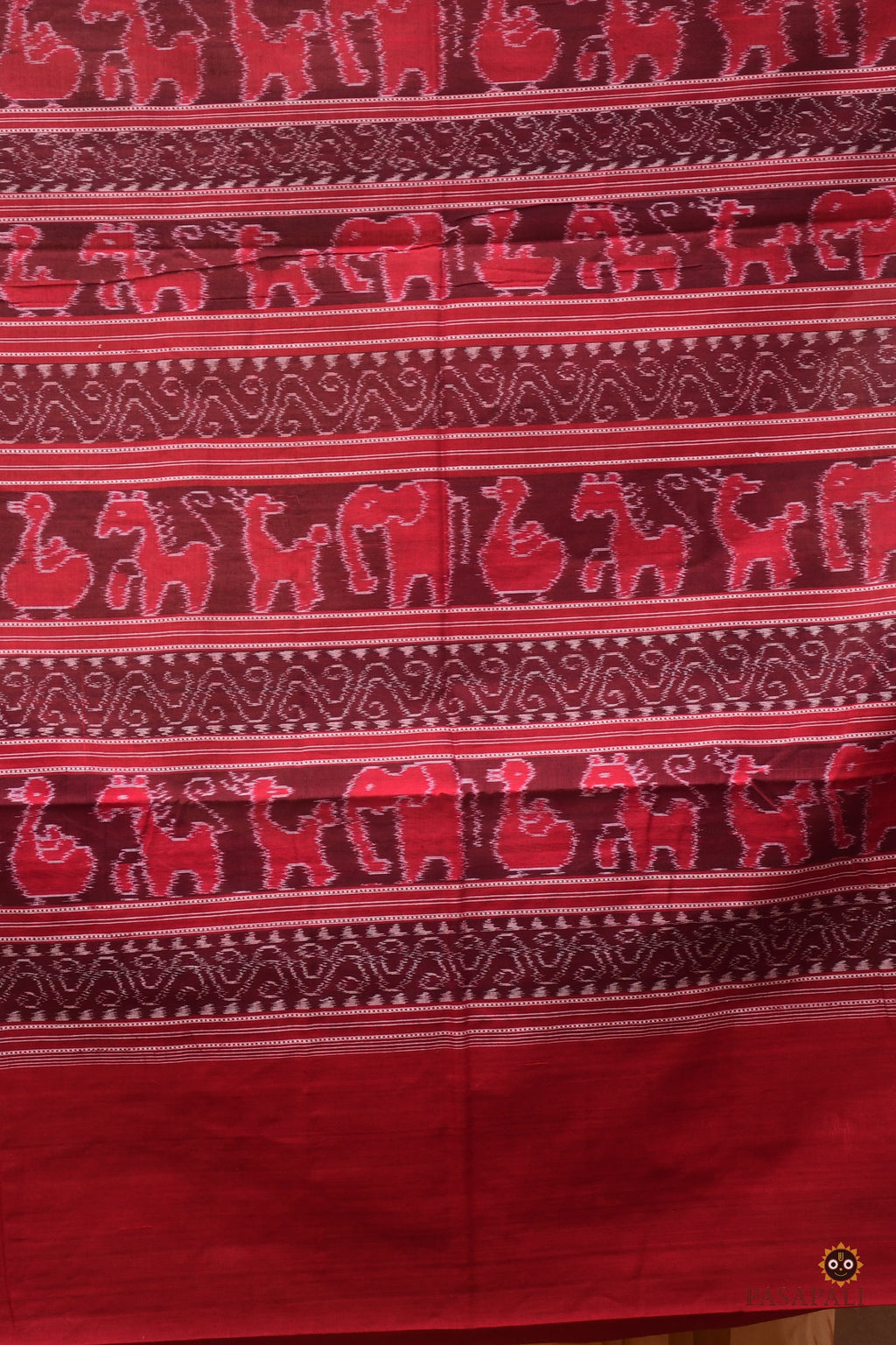 Border motif close-up on Sunanda — chevron ikat pattern in maroon on authentic Sambalpuri Bandha mercerized cotton saree