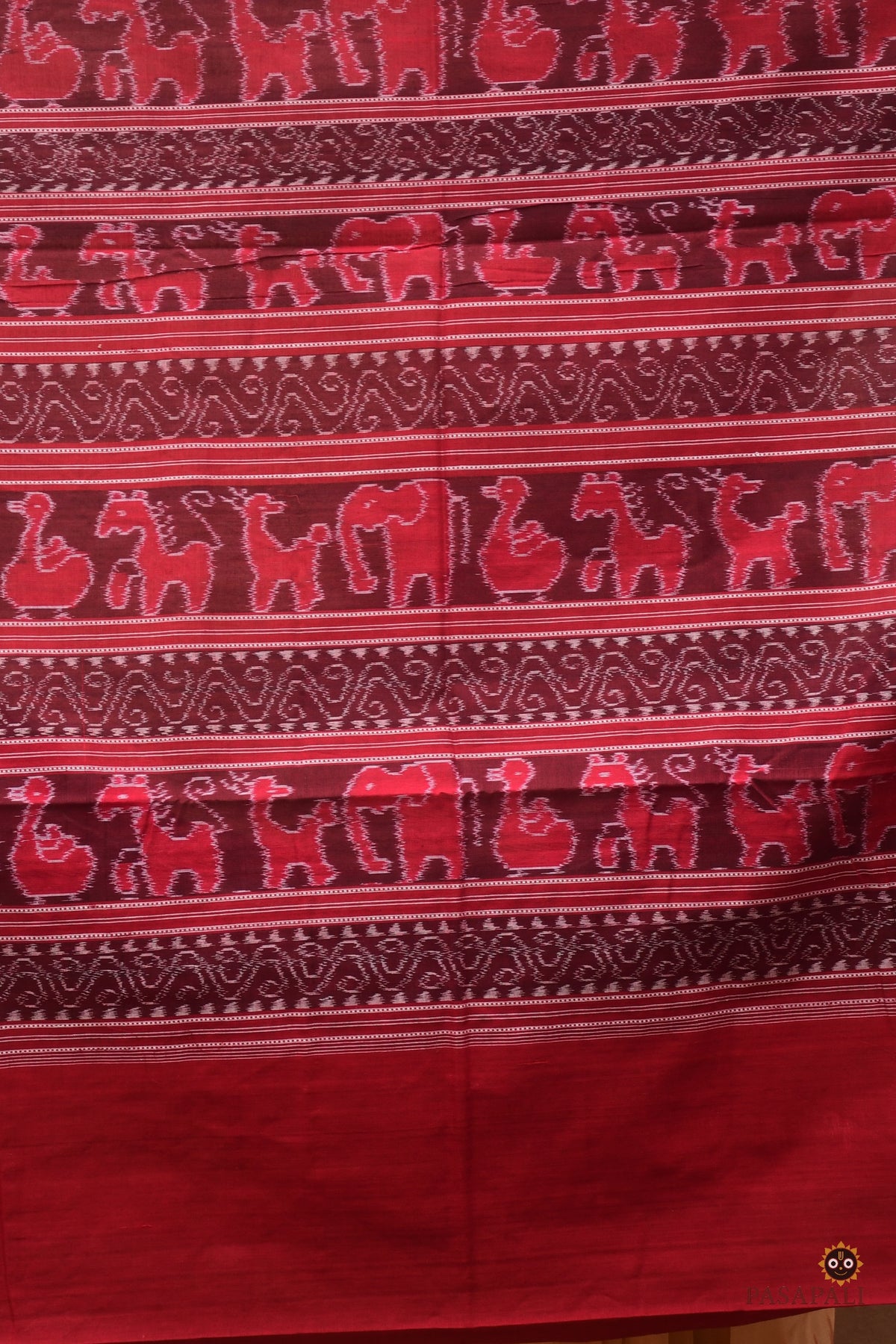 Border motif close-up on Sunanda — chevron ikat pattern in maroon on authentic Sambalpuri Bandha mercerized cotton saree