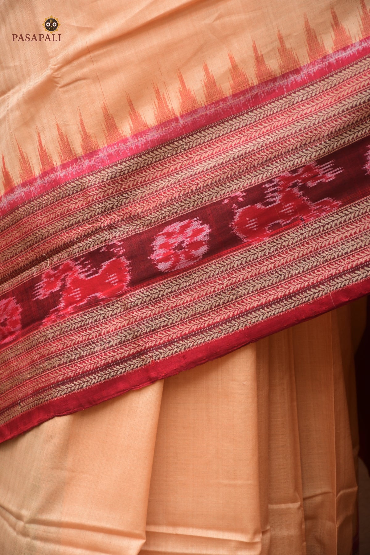 Sunanda Sambalpuri cotton saree front drape — maroon ikat border with flower and fish motifs on light brown body
