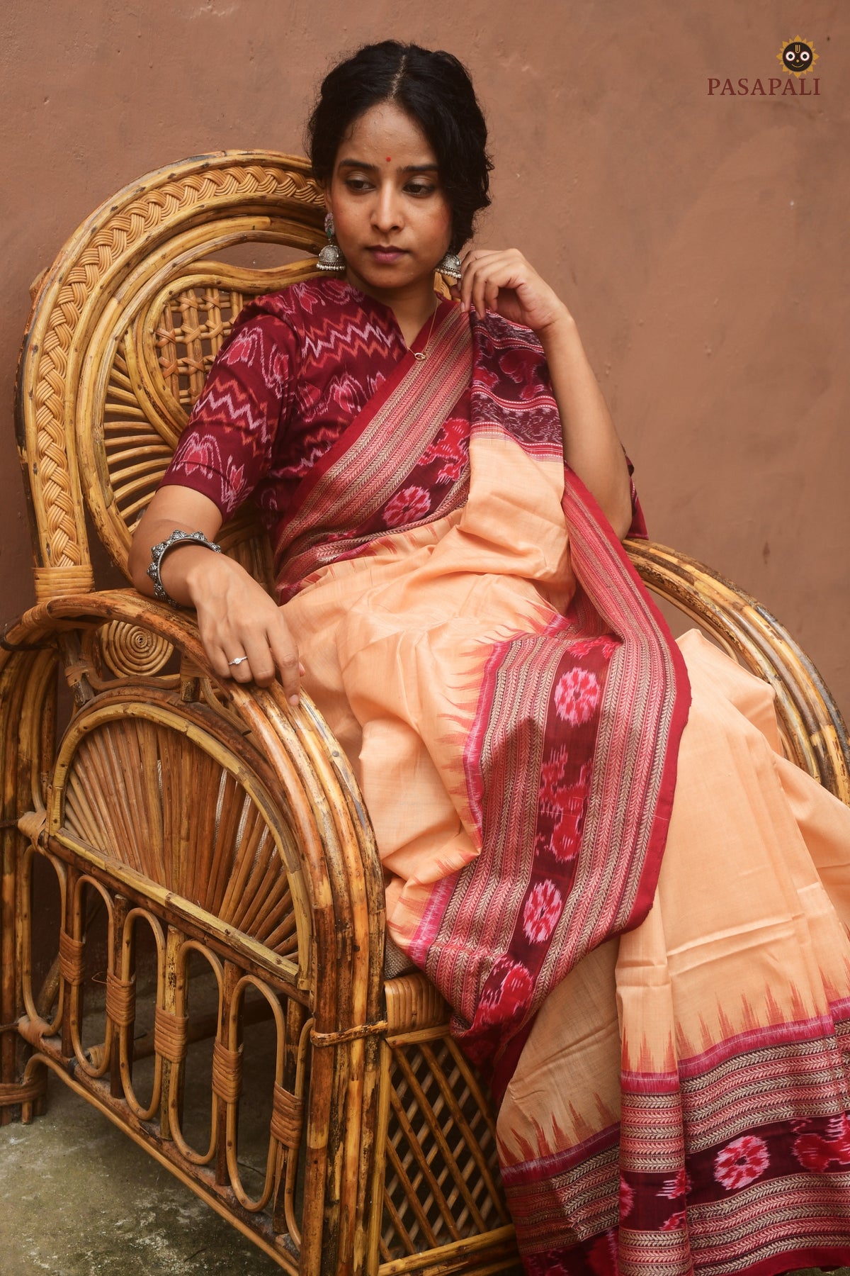 Sunanda pallu close-up — flower, fish, duck, deer, elephant ikat motifs in maroon on Sambalpuri cotton saree
