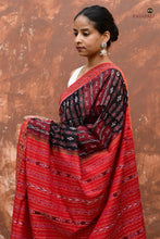 Load image into Gallery viewer, Tilottama authentic Sambalpuri handloom saree draped view — black body with ikat vertical stripes, red pallu, Pasapali Odisha
