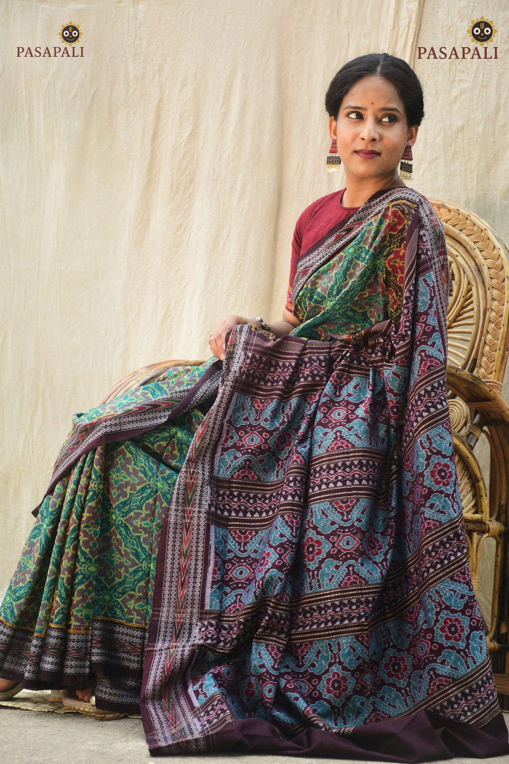 Vanalata green Sambalpuri cotton saree folded flat — Rudraksha border and Plula motif visible, Pasapali