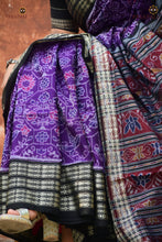 Load image into Gallery viewer, Handloom drape view of Vasundhara — authentic Sambalpuri Bandha mercerized cotton saree in purple and black. Pasapali.
